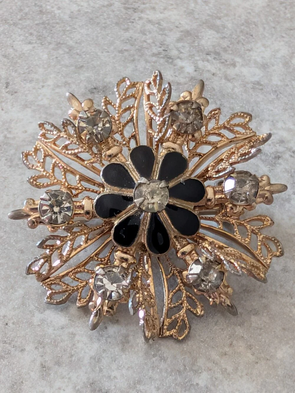 Gold-Tone Filigree Floral Starburst Brooch with Black Enamel and Clear Crystals